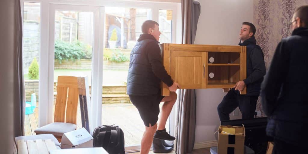 Workers removing furniture from a home