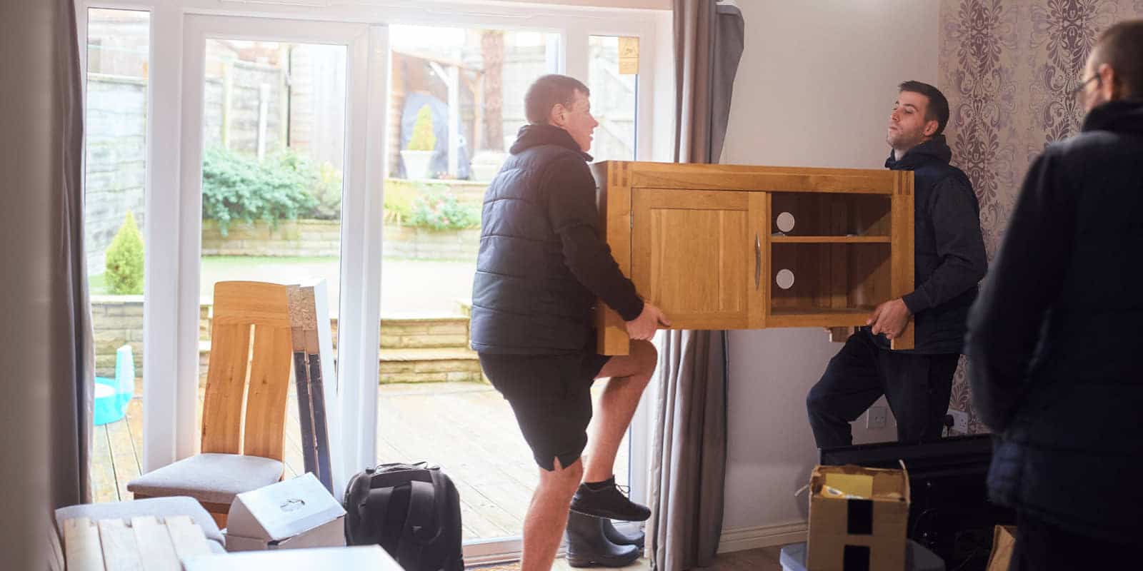 Workers removing furniture from a home