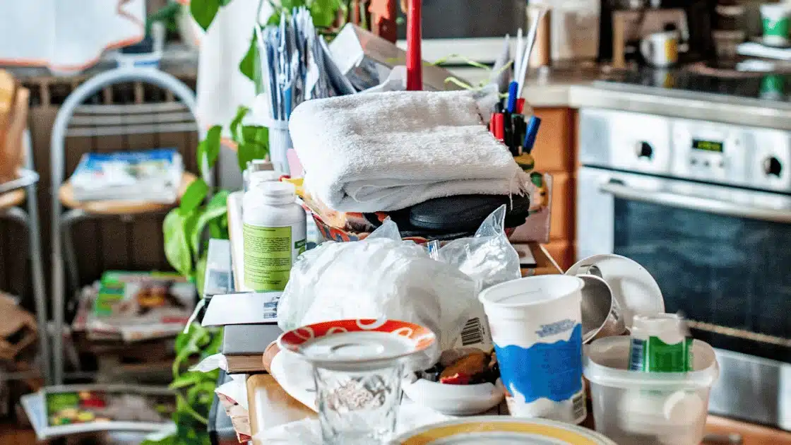 Cluttered kitchen counter with various household items.