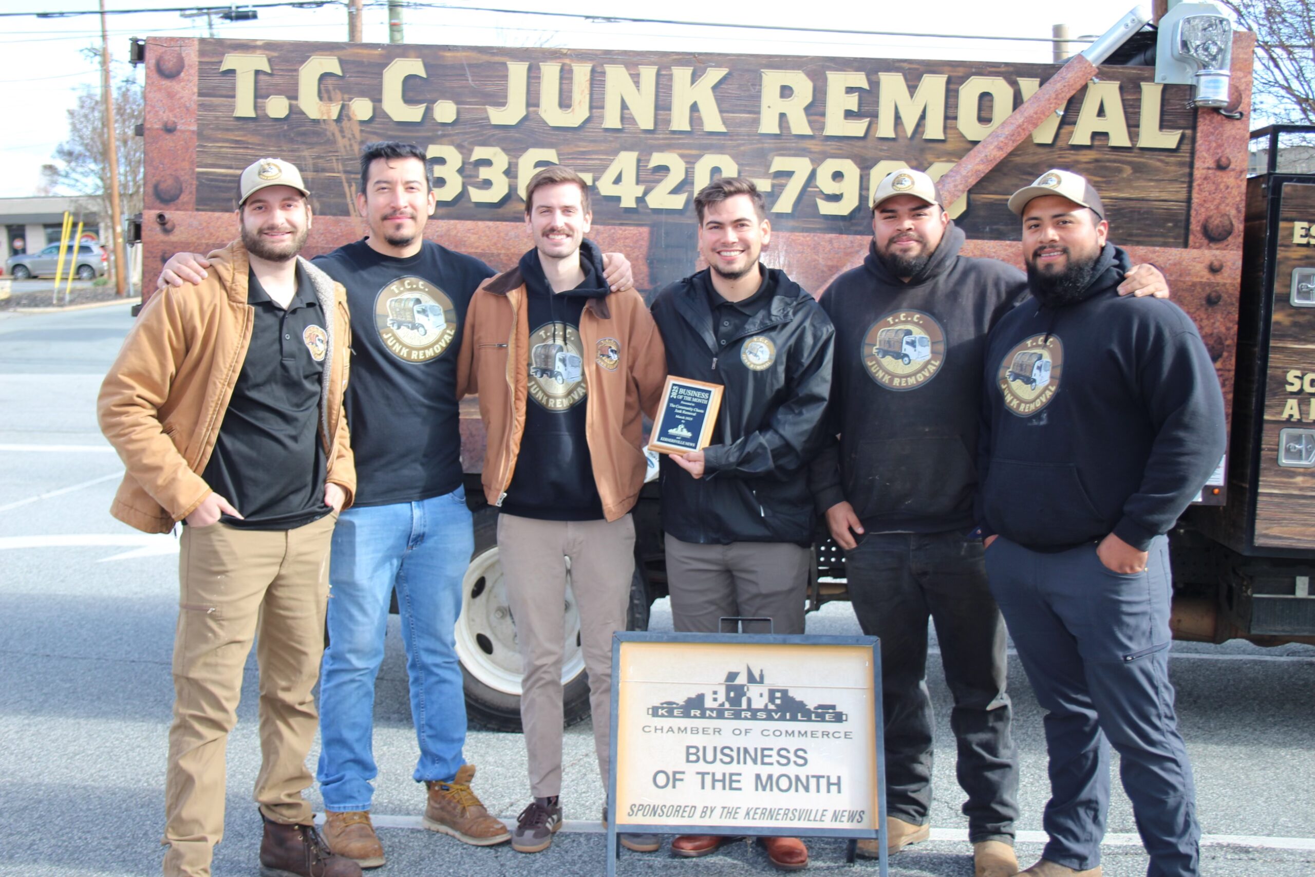 Award-winning business team poses for group photo.